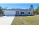 Charming single-story home with a well-manicured lawn and attached two-car garage at 20154 Sw Rainbow Lakes Blvd, Dunnellon, FL 34431