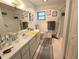 Bright bathroom with white cabinets, mirror, vanity and bathtub with shower at 2131 Ne 145Th Avenue Rd, Silver Springs, FL 34488