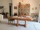 Open-concept dining area featuring a wooden dining table, chairs, and a decorative china cabinet at 2131 Ne 145Th Avenue Rd, Silver Springs, FL 34488