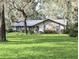 Charming single-story home featuring stone accents and a well-manicured lawn at 2131 Ne 145Th Avenue Rd, Silver Springs, FL 34488