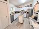 Functional kitchen featuring bright cabinets, stainless steel appliances, and an island at 2131 Ne 145Th Avenue Rd, Silver Springs, FL 34488