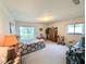 Spacious main bedroom with natural light, a sliding glass door, carpet flooring and ample closet space at 2131 Ne 145Th Avenue Rd, Silver Springs, FL 34488