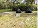 Backyard patio featuring a brick path and covered outdoor furniture at 2131 Ne 145Th Avenue Rd, Silver Springs, FL 34488