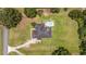 An aerial view of a home with a swimming pool, surrounded by a spacious lawn and mature trees at 2151 Se 59Th St, Ocala, FL 34480