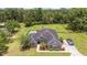 Aerial view of home featuring a dark roof, pool, and fenced yard at 2151 Se 59Th St, Ocala, FL 34480
