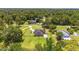 Aerial view of a home with a pool, fenced yard, and surrounded by lush trees at 2151 Se 59Th St, Ocala, FL 34480