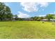 Expansive grassy backyard with a house in the distance and a fenced perimeter at 2151 Se 59Th St, Ocala, FL 34480