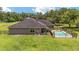 A serene backyard featuring a fenced pool area and green lawn at 2151 Se 59Th St, Ocala, FL 34480