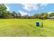 A spacious backyard with green lawn, mature trees and view of the house at 2151 Se 59Th St, Ocala, FL 34480