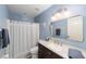 Bathroom featuring dark wood cabinets, white quartz countertops, and a shower-tub combo at 2151 Se 59Th St, Ocala, FL 34480