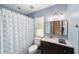 Bathroom featuring dark wood cabinets, white quartz countertops, and a shower-tub combo at 2151 Se 59Th St, Ocala, FL 34480