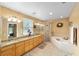 Bright bathroom featuring granite countertops, double vanity, bathtub and walk-in shower at 2151 Se 59Th St, Ocala, FL 34480
