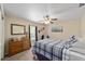 Cozy bedroom featuring a plaid bedspread, ceiling fan, and warm neutral walls at 2151 Se 59Th St, Ocala, FL 34480