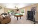 Large bonus room with pool table, treadmill, and sliding glass door to the backyard at 2151 Se 59Th St, Ocala, FL 34480