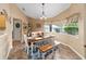 Cozy dining room with a wooden table, bench seating, and a large window with floral valance at 2151 Se 59Th St, Ocala, FL 34480