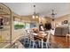 Inviting dining area with wooden table and chairs, with view of living room and natural light at 2151 Se 59Th St, Ocala, FL 34480