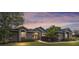 Charming home with stone accents, manicured landscaping, and warm evening glow at 2151 Se 59Th St, Ocala, FL 34480