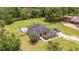 An exterior view of a home with a swimming pool, lush greenery and a fenced backyard at 2151 Se 59Th St, Ocala, FL 34480