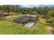 A backyard with a swimming pool and an exterior view of the house at 2151 Se 59Th St, Ocala, FL 34480