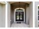 Inviting front entrance featuring double doors, decorative wreaths, and elegant tile flooring at 2151 Se 59Th St, Ocala, FL 34480
