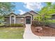 Inviting home featuring stone accents, a well-manicured yard, and a charming walkway at 2151 Se 59Th St, Ocala, FL 34480