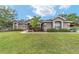 Charming home with well-manicured lawn, stone accents, and inviting walkway at 2151 Se 59Th St, Ocala, FL 34480
