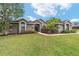 Inviting home exterior with lush green lawn, decorative stone accents, and manicured landscaping at 2151 Se 59Th St, Ocala, FL 34480