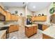 Bright kitchen features wood cabinetry, central island, and granite countertops for a stylish, functional cooking space at 2151 Se 59Th St, Ocala, FL 34480