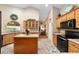Eat-in kitchen features an island, tile floors, and modern appliances for functional cooking and dining at 2151 Se 59Th St, Ocala, FL 34480
