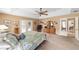 Spacious main bedroom with carpet flooring, ceiling fan, and glass doors to the exterior at 2151 Se 59Th St, Ocala, FL 34480