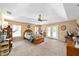 Bright main bedroom featuring a tray ceiling, ceiling fan, carpet, and french doors to the backyard at 2151 Se 59Th St, Ocala, FL 34480