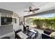 Spacious outdoor patio with fan and seating offers a comfortable and stylish entertainment area at 2151 Se 59Th St, Ocala, FL 34480