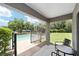 Covered patio with pool view overlooking well-maintained lawn offers great outdoor relaxation space at 2151 Se 59Th St, Ocala, FL 34480