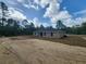Back exterior view of home, featuring an expansive backyard at 23213 Nw Mallard Ave, Dunnellon, FL 34431