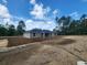 Back exterior view of home, featuring an expansive backyard at 23213 Nw Mallard Ave, Dunnellon, FL 34431