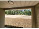View of the home's backyard from the covered patio, featuring plenty of trees at 23213 Nw Mallard Ave, Dunnellon, FL 34431