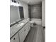 Bathroom with granite countertop, tile backsplash, and modern fixtures at 23213 Nw Mallard Ave, Dunnellon, FL 34431