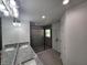 Bathroom showcasing double sinks, granite countertops, a large mirror, and a spacious glass-enclosed shower at 23213 Nw Mallard Ave, Dunnellon, FL 34431