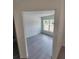 Bright bedroom featuring a light gray floor and a large window at 23213 Nw Mallard Ave, Dunnellon, FL 34431