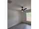 Bedroom featuring a ceiling fan and a window overlooking lush greenery at 23213 Nw Mallard Ave, Dunnellon, FL 34431