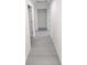 Hallway with gray flooring leads to multiple rooms and a storage area at 23213 Nw Mallard Ave, Dunnellon, FL 34431