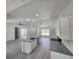 Modern kitchen featuring granite countertops, a large island, stainless appliances and gray wood floors at 23213 Nw Mallard Ave, Dunnellon, FL 34431
