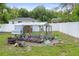 Spacious fenced backyard featuring a chicken coop at 2924 Se 142Nd Pl, Summerfield, FL 34491