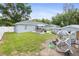 A lovely backyard with a chicken coop, a pool, a patio, and a privacy fence at 2924 Se 142Nd Pl, Summerfield, FL 34491