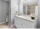 Bathroom boasts a white vanity, modern lighting, and a shower with tiled walls at 2924 Se 142Nd Pl, Summerfield, FL 34491