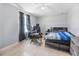 Comfortable bedroom with ceiling fan, wood-look floors, and ample natural light at 2924 Se 142Nd Pl, Summerfield, FL 34491