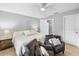 Bright bedroom features a ceiling fan and a cozy seating area with two armchairs at 2924 Se 142Nd Pl, Summerfield, FL 34491