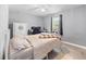 Comfortable bedroom with ceiling fan, wood-look floors, and ample natural light at 2924 Se 142Nd Pl, Summerfield, FL 34491