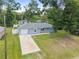 Charming single-story home with a well-maintained lawn, front porch and a long driveway at 2924 Se 142Nd Pl, Summerfield, FL 34491