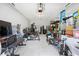 Spacious garage featuring a home gym, ample storage, and well-organized equipment at 2924 Se 142Nd Pl, Summerfield, FL 34491